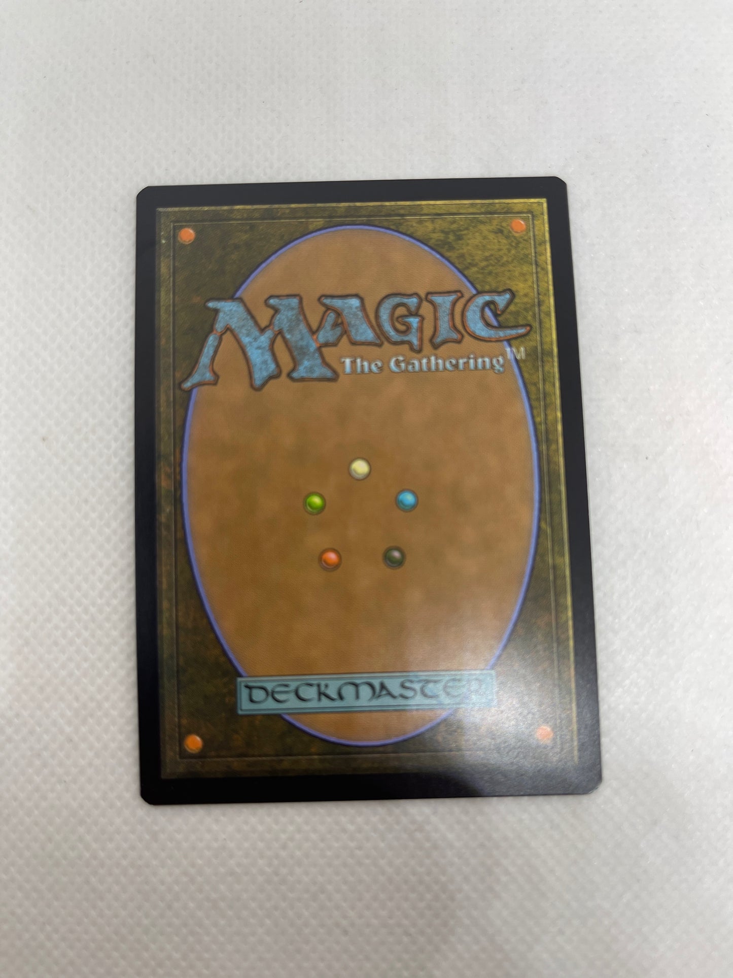 Trading card with 'Magic: The Gathering' logo and multicolored dots on a textured gray background