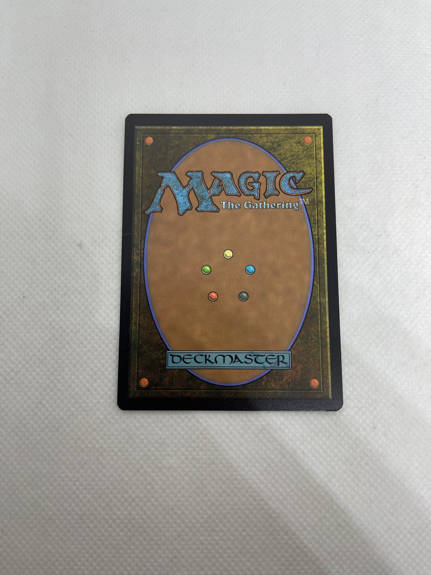Magic: The Gathering card with colorful mana symbols on a textured gray background