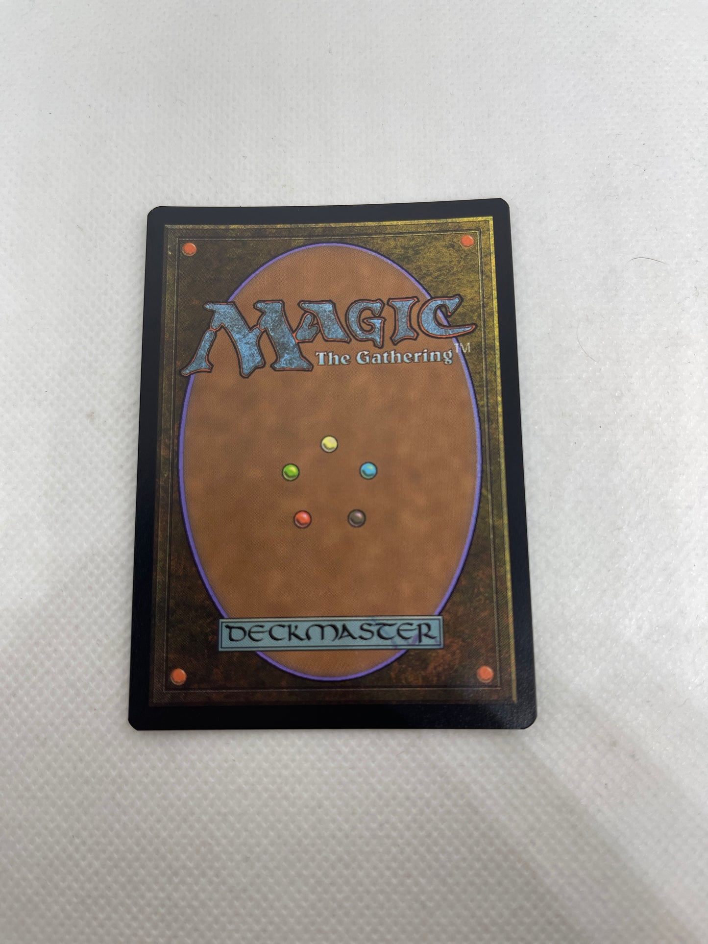 Magic: The Gathering deck binder with colorful beads on a white background