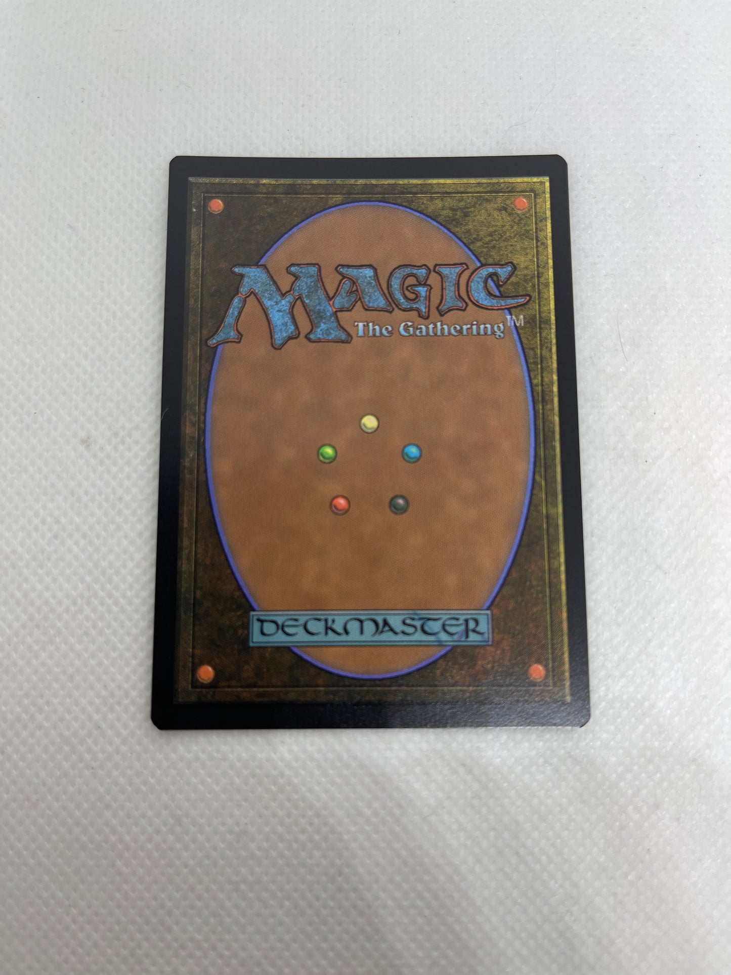 Card from 'Magic: The Gathering' with colorful dots on a white background