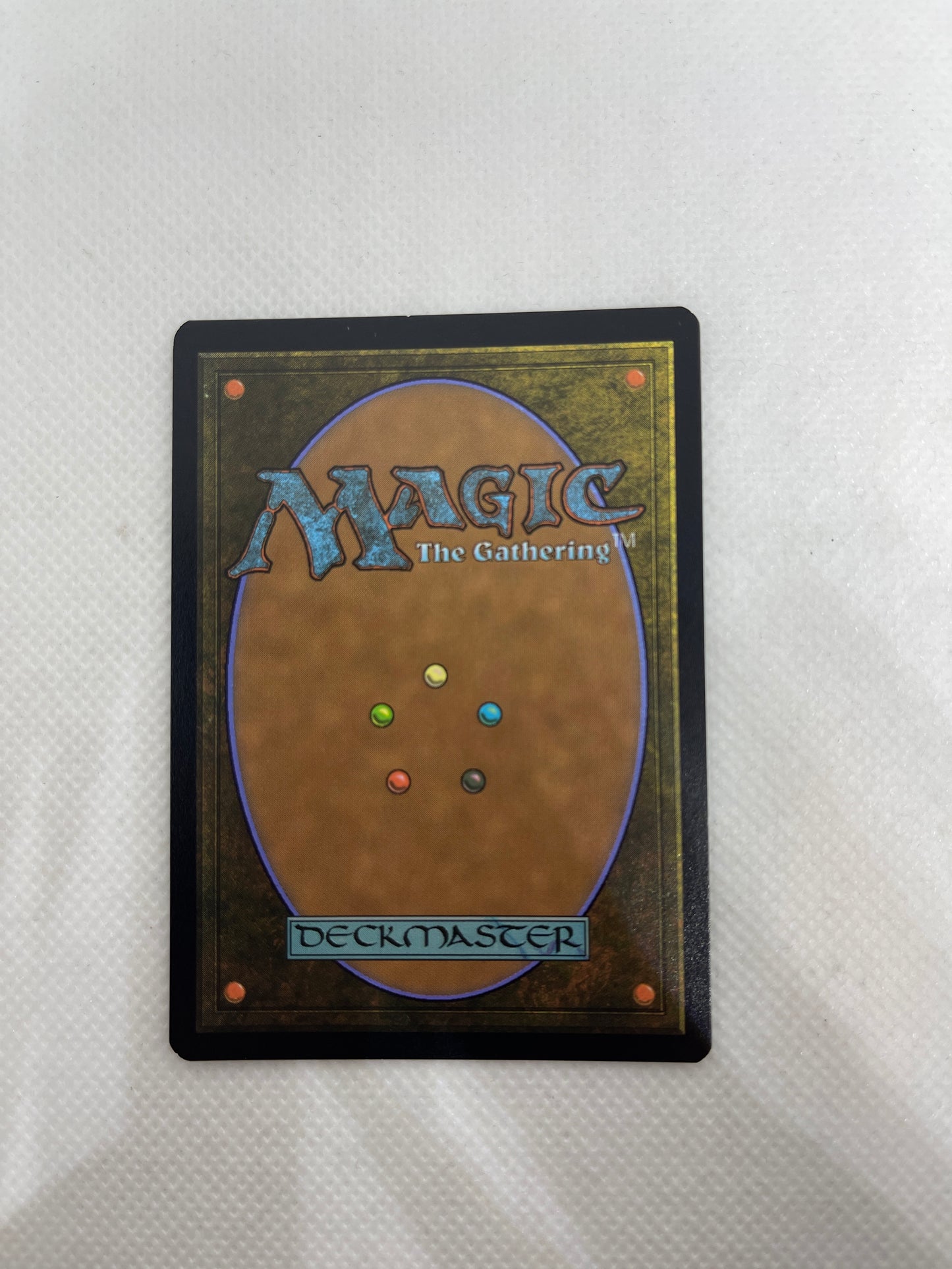Card from 'Magic: The Gathering' with colorful dots on a white background