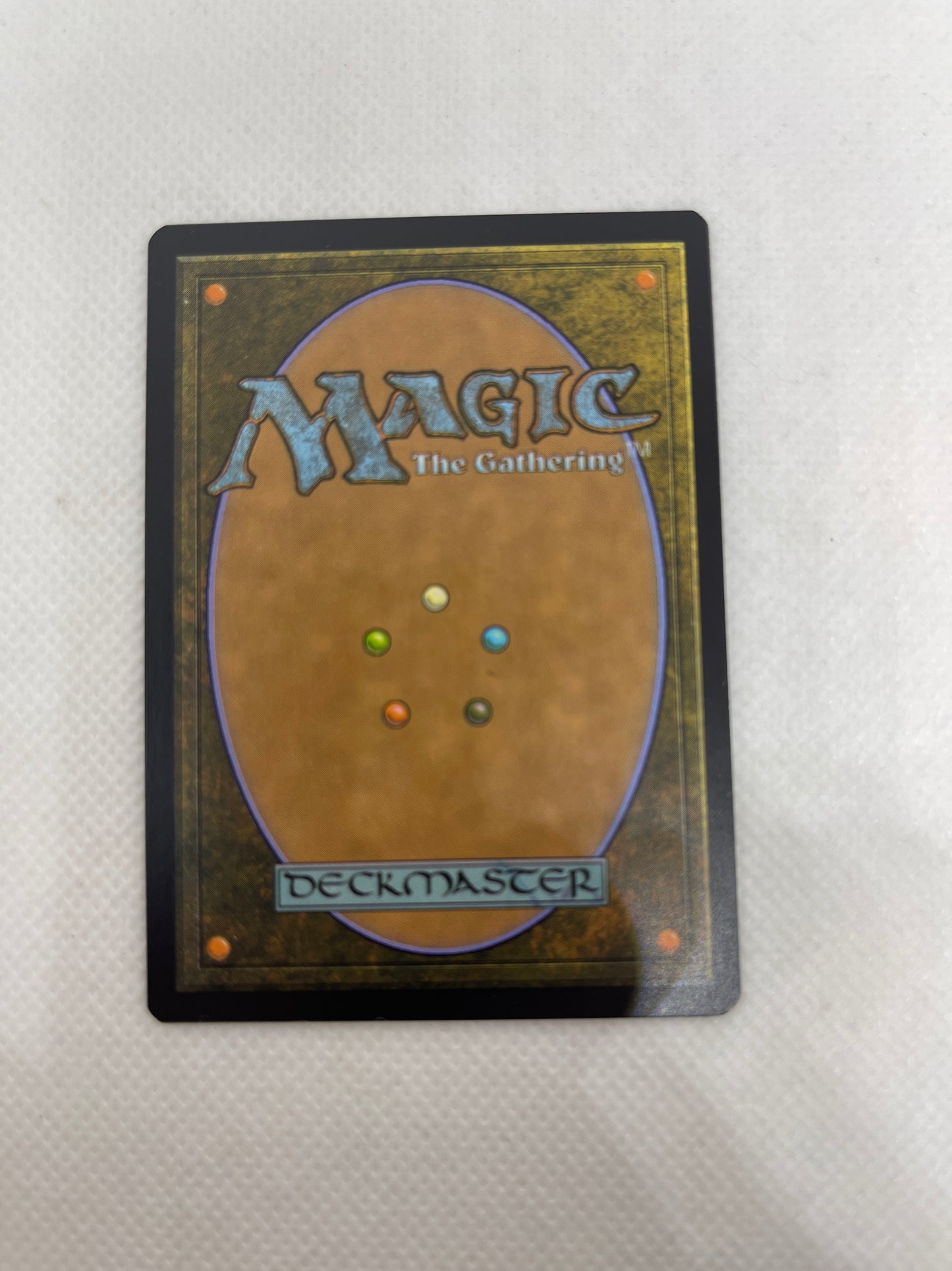 Trading card from 'Magic: The Gathering' with colorful dots on a textured surface