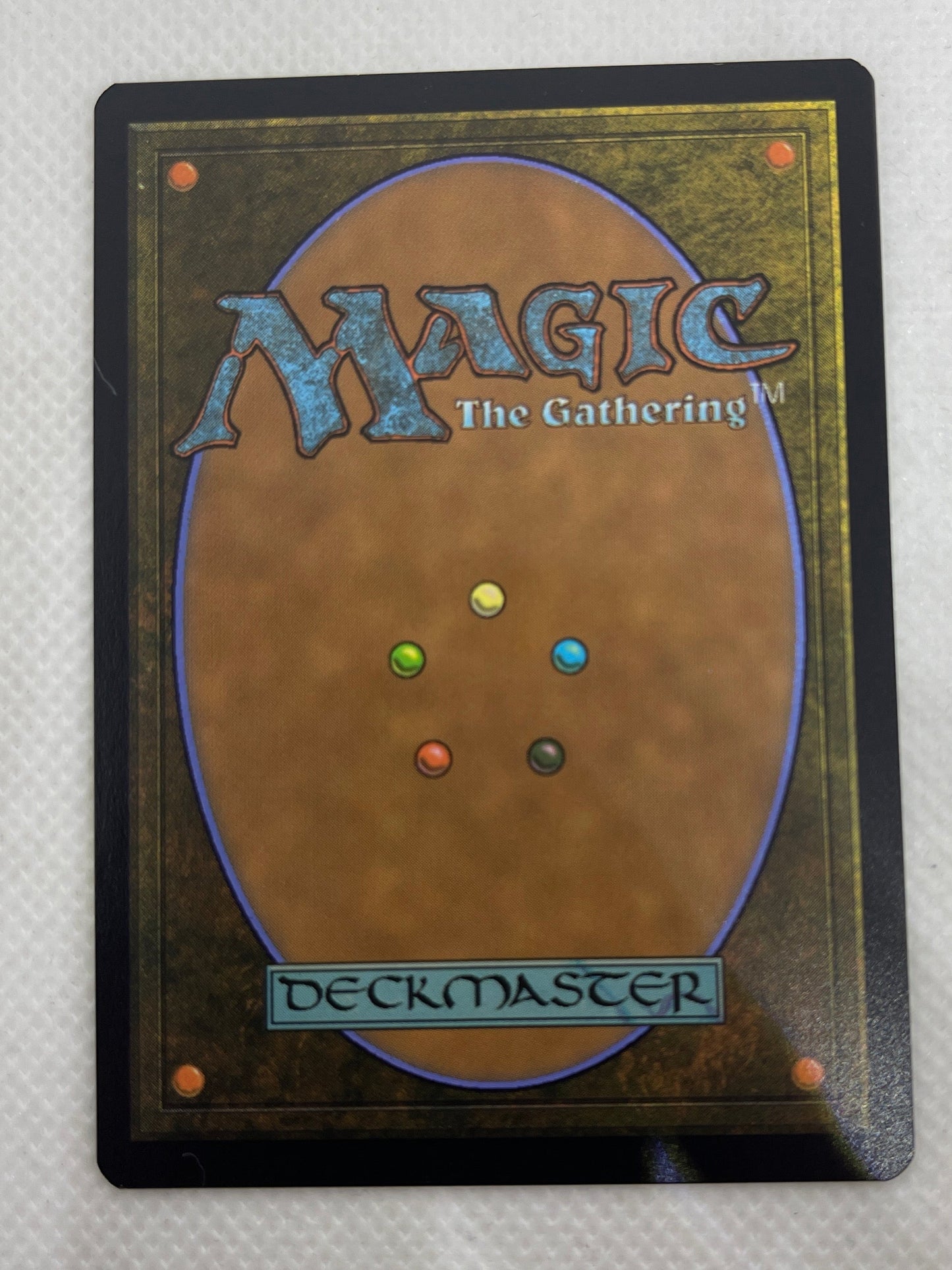 Card from 'Magic: The Gathering' with colorful game pieces on a textured white background