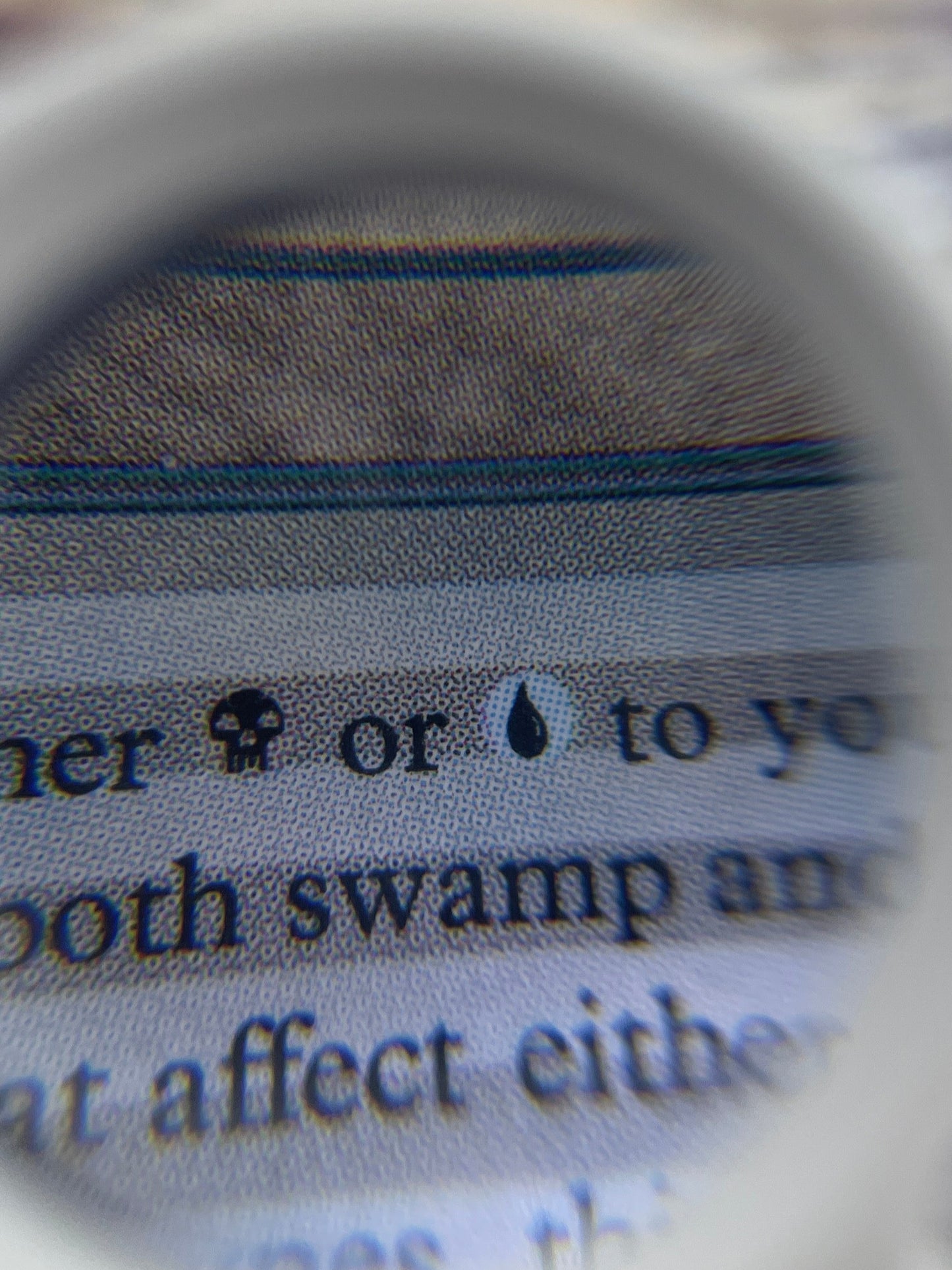 Close-up of a card with text and an image, magnified by a magnifying glass.