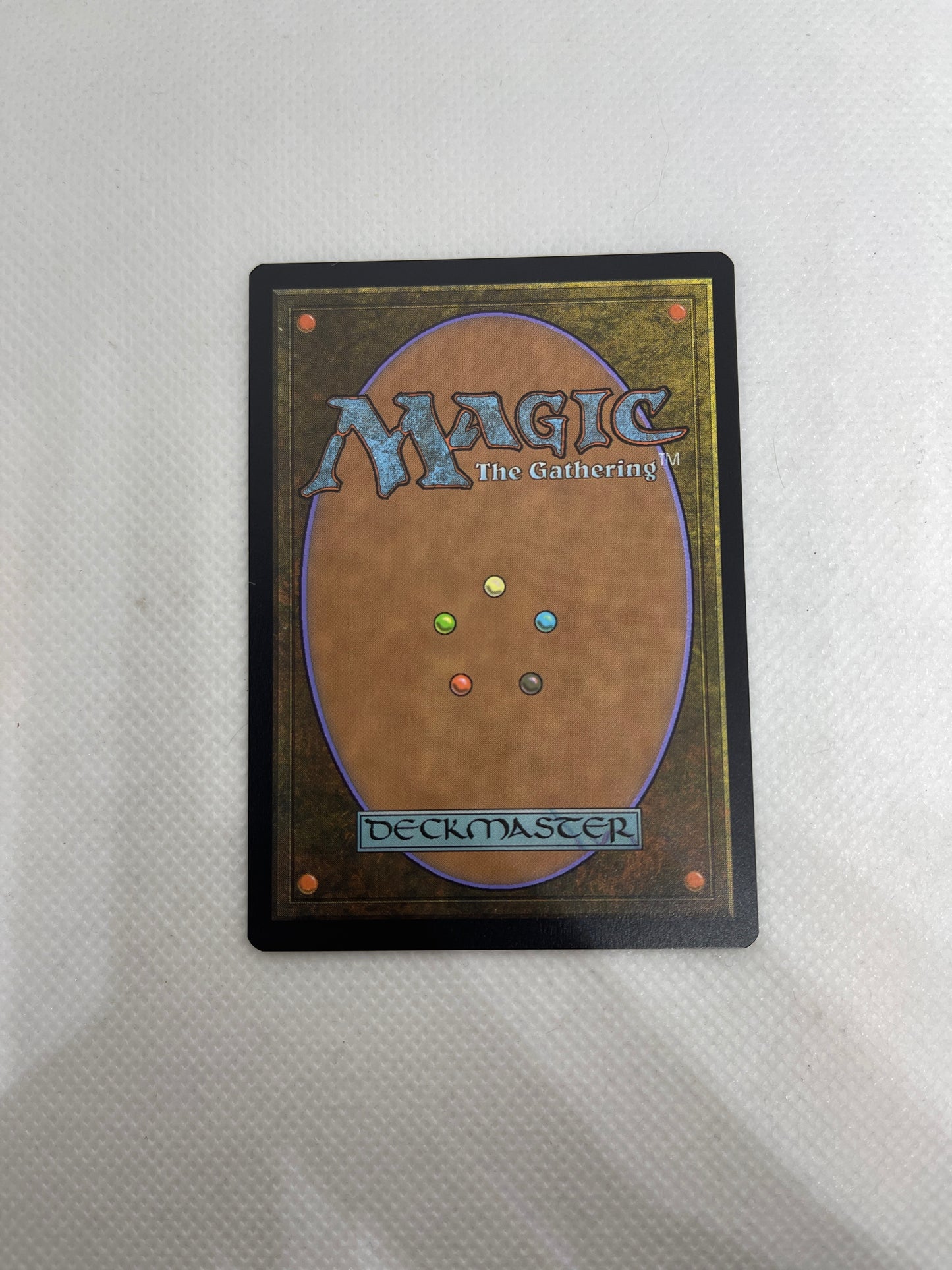 Card from 'Magic: The Gathering' with colorful dots on a white background