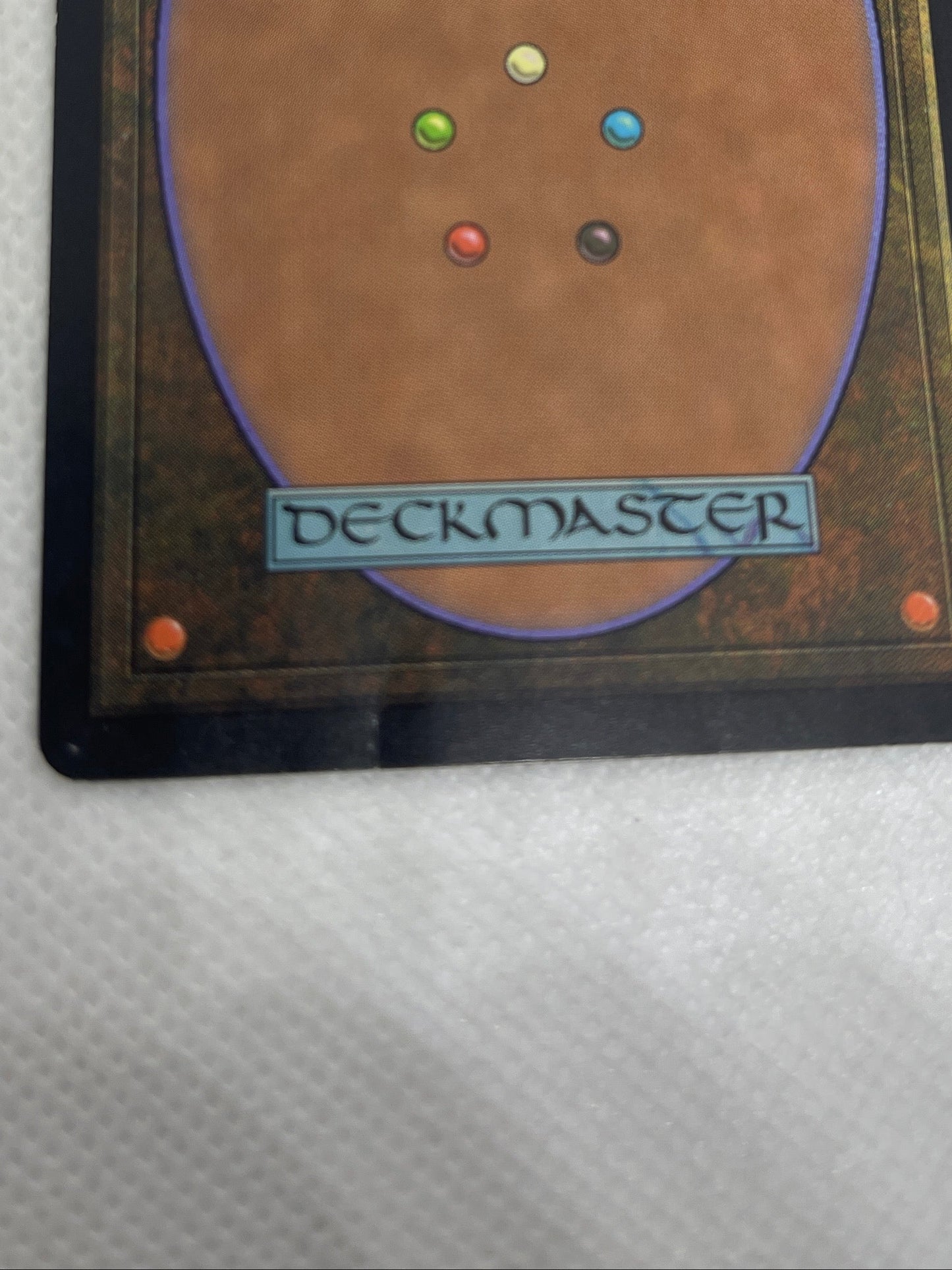 Trading card from 'Magic: The Gathering' with colorful dots on a textured white background