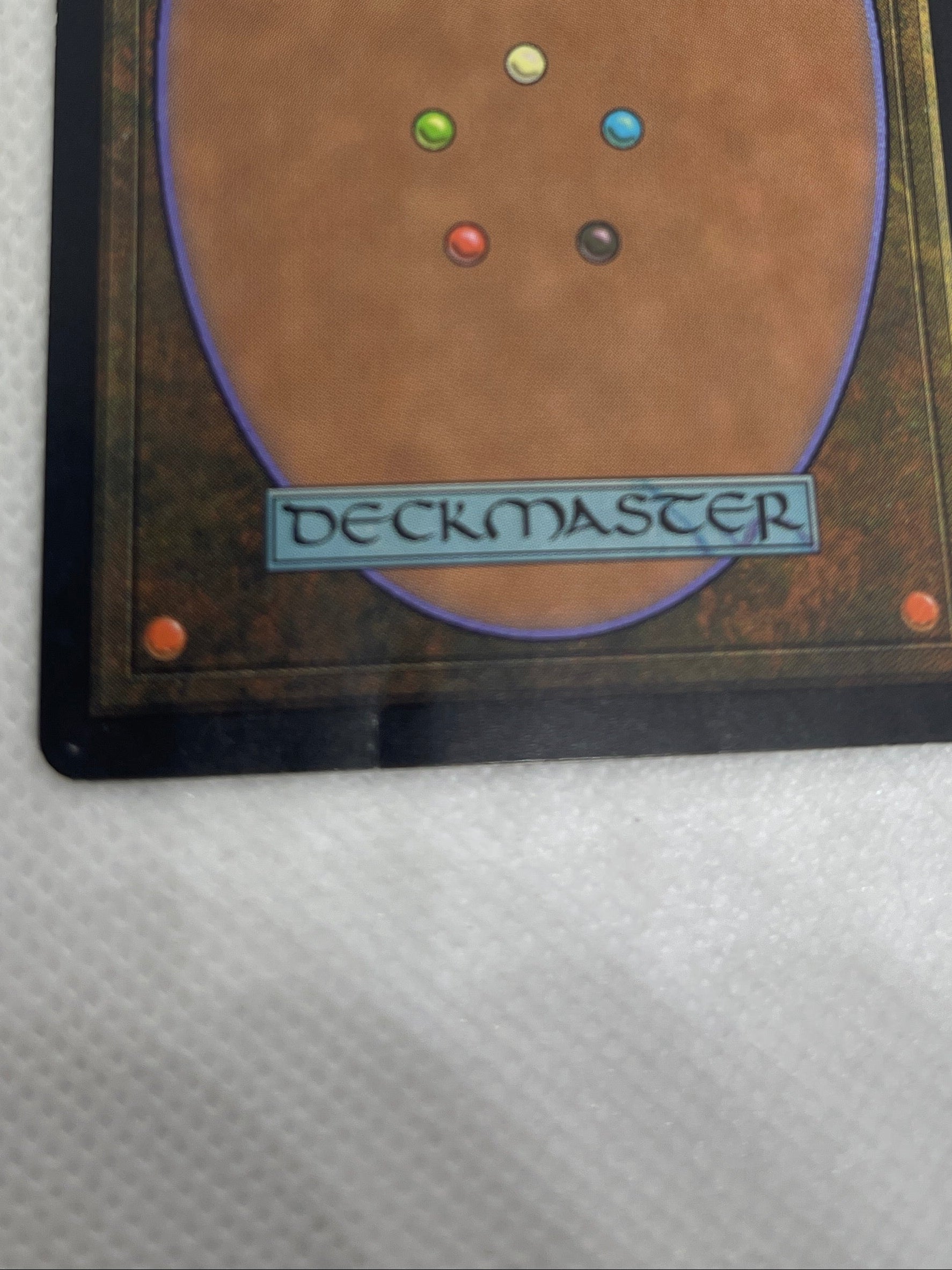 Trading card from 'Magic: The Gathering' with colorful dots on a textured white background