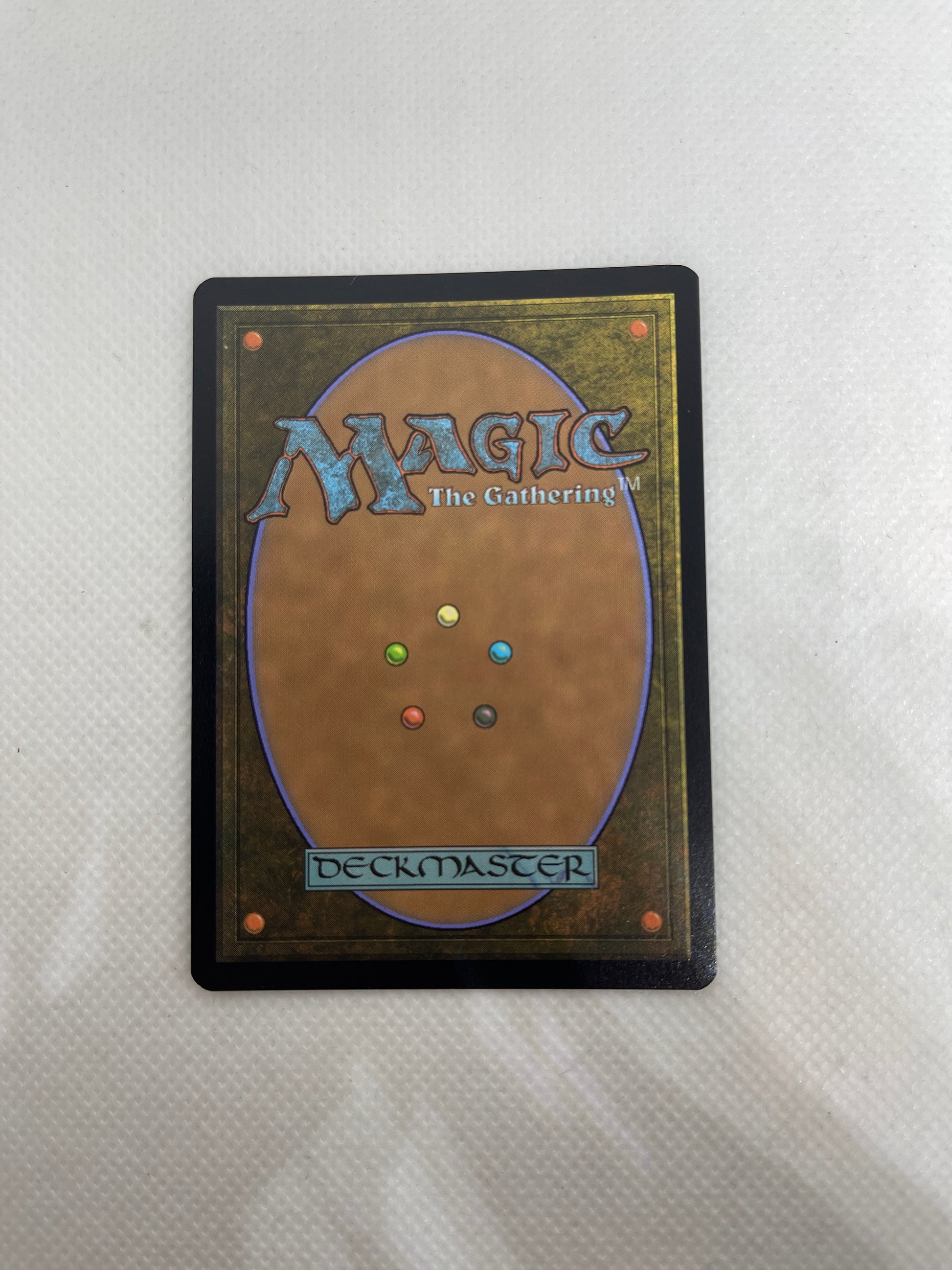 Trading card from 'Magic: The Gathering' with colorful mana symbols on a white background