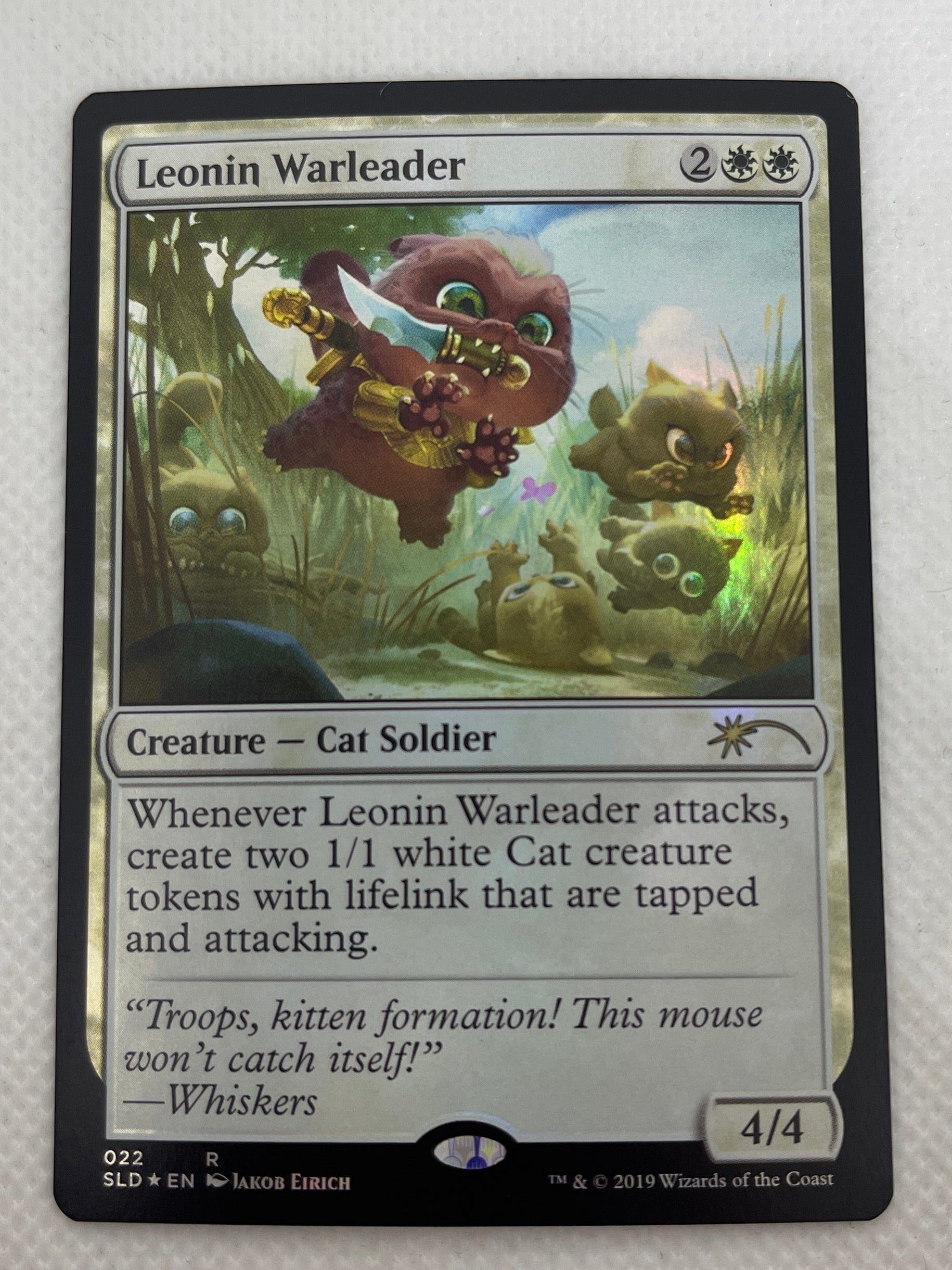Trading card featuring a creature illustration on a white surface