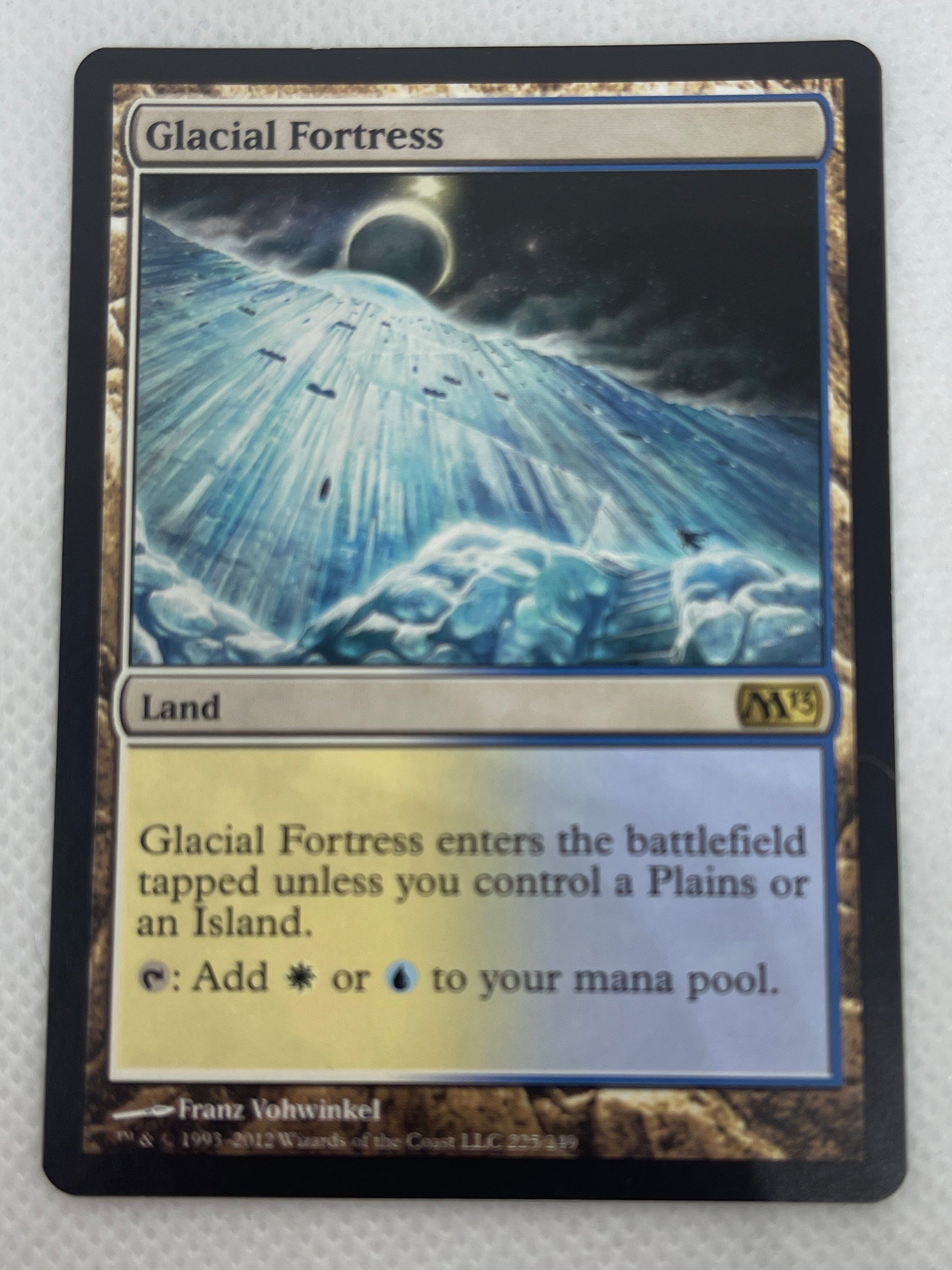 Trading card featuring a celestial scene on a metallic surface