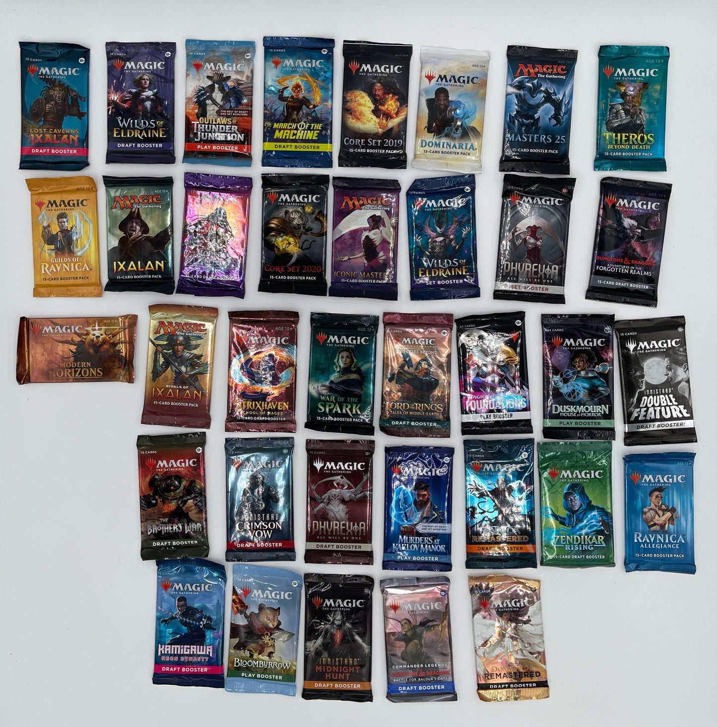 Collection of trading card packs arranged in a grid on a white surface
