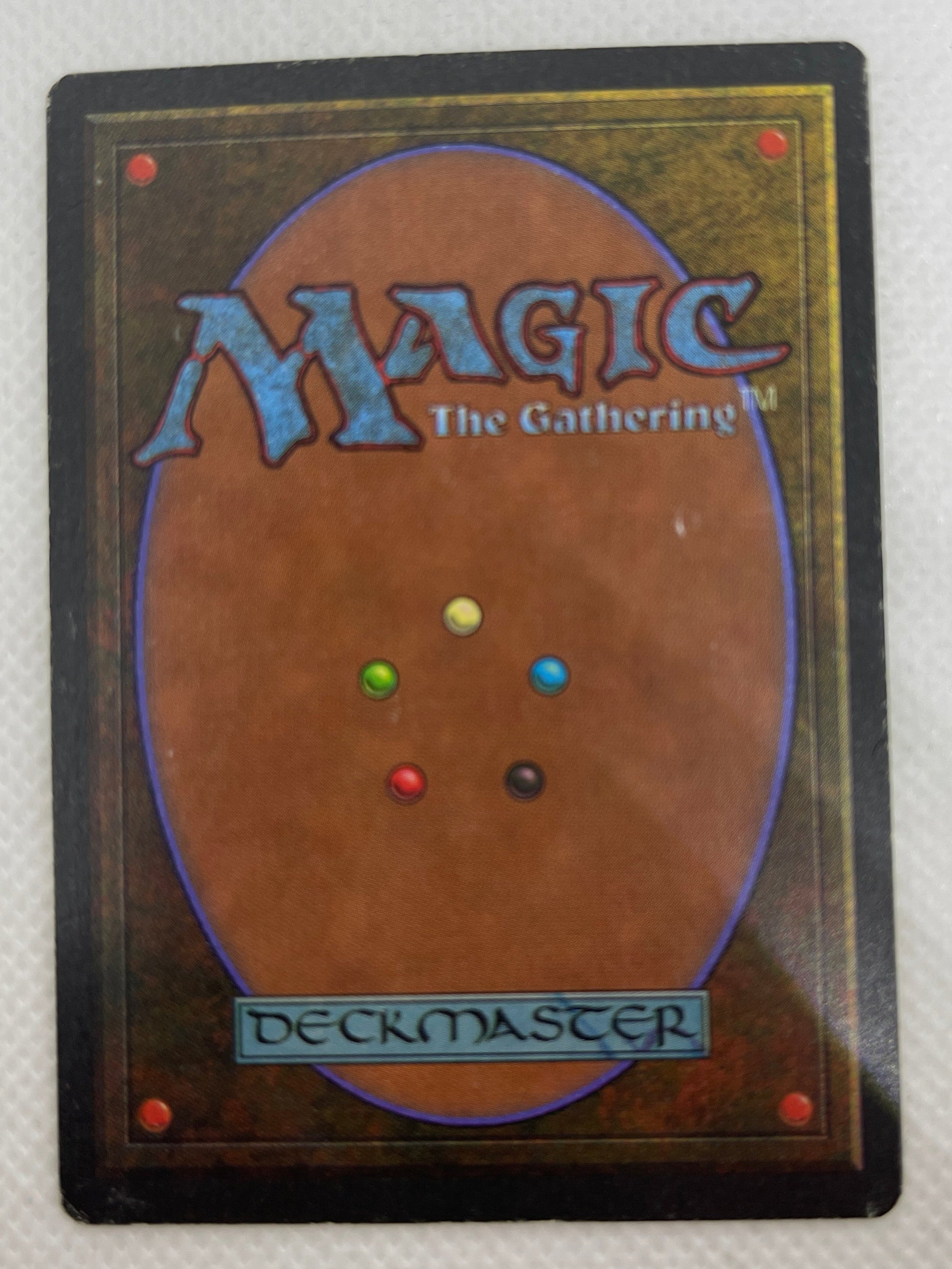 Trading card from 'Magic: The Gathering' with multicolored dots on a textured white background