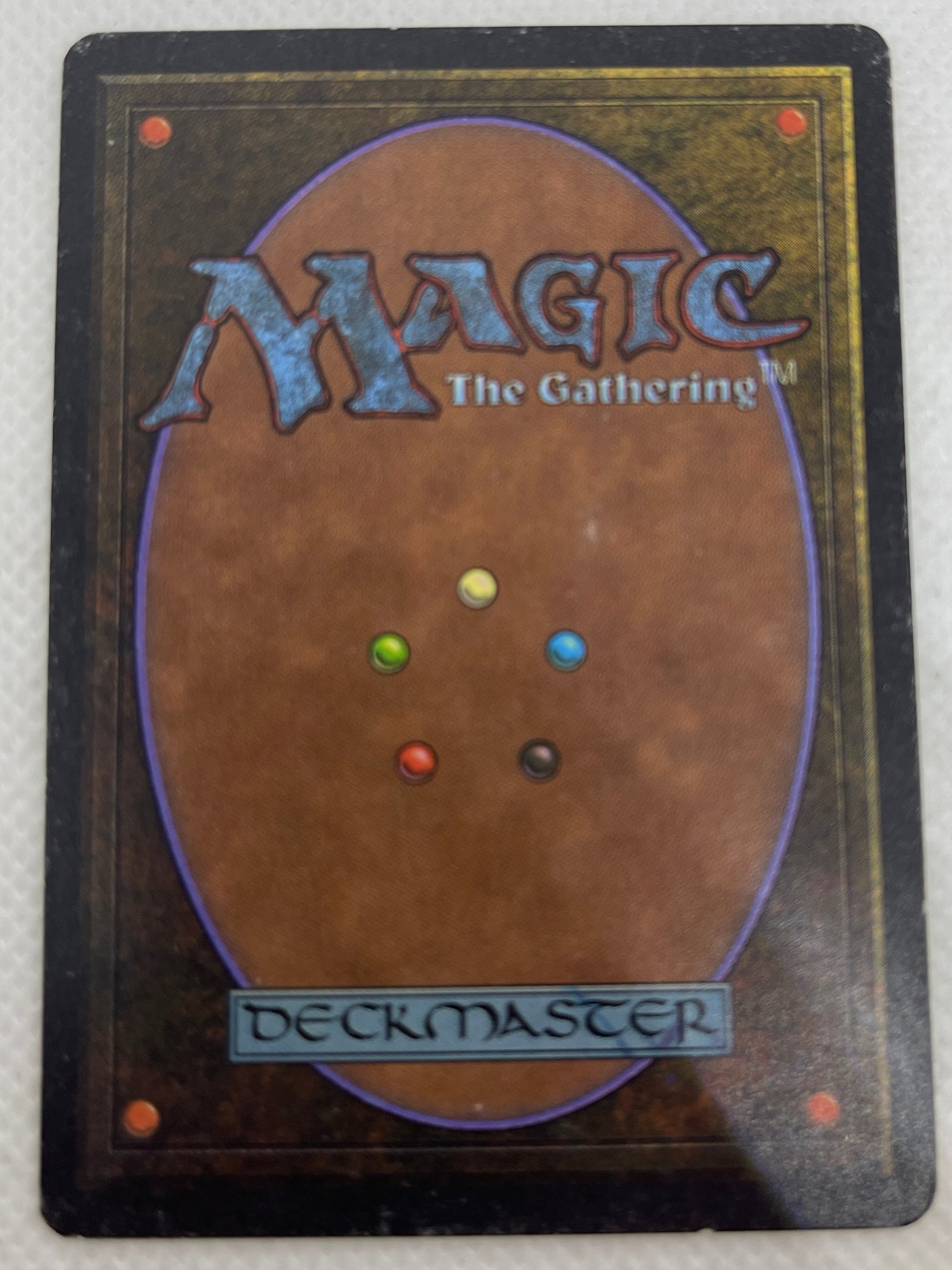 Card from 'Magic: The Gathering' with multicolored dots on a textured white background