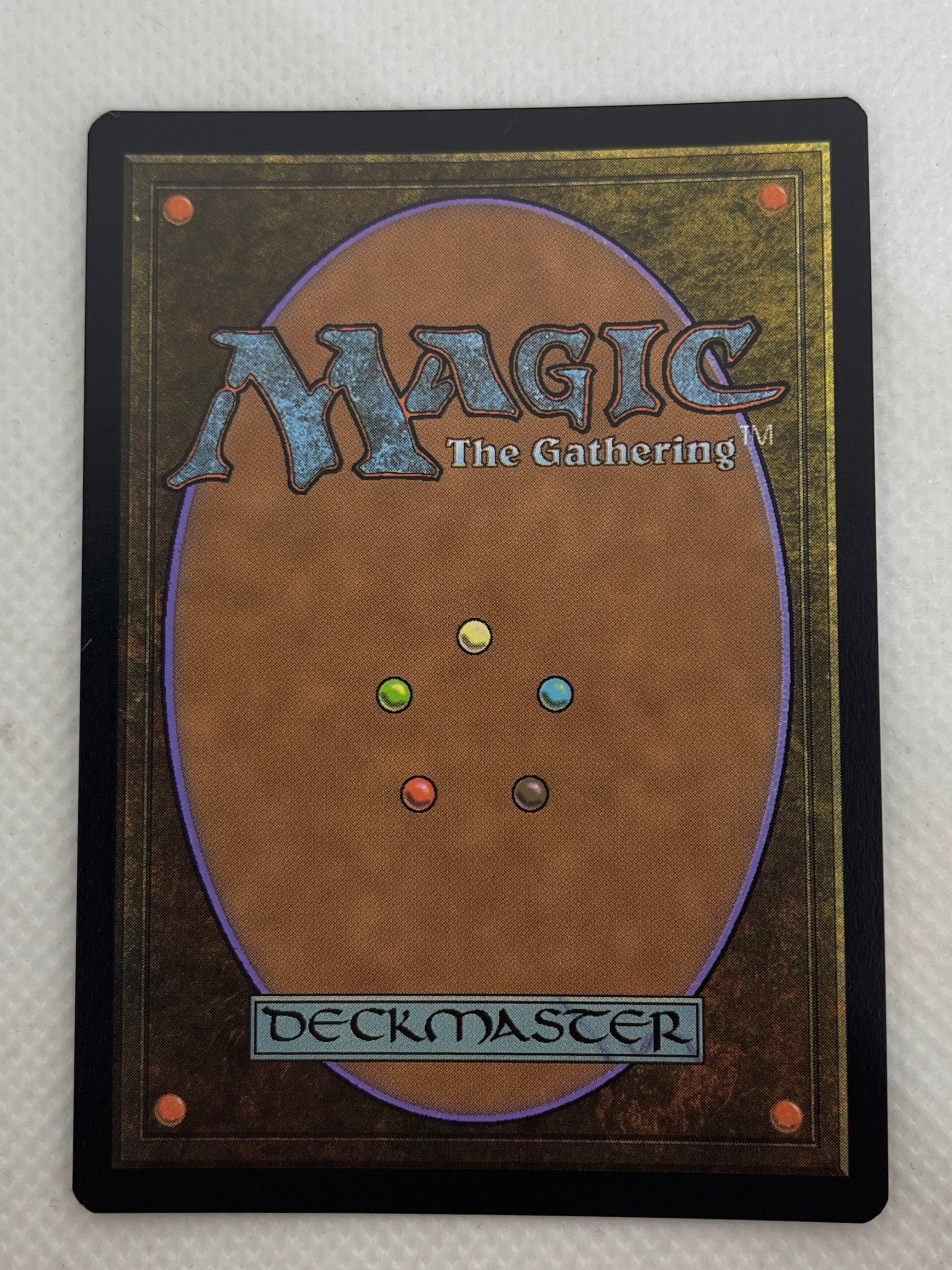 Trading card with 'Magic: The Gathering' logo on a textured surface