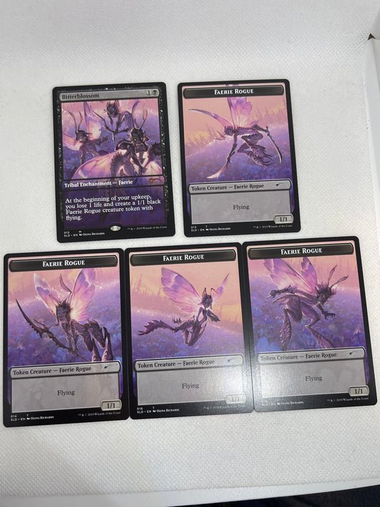 Five trading cards featuring a purple and black dragon-like creature on a white surface.