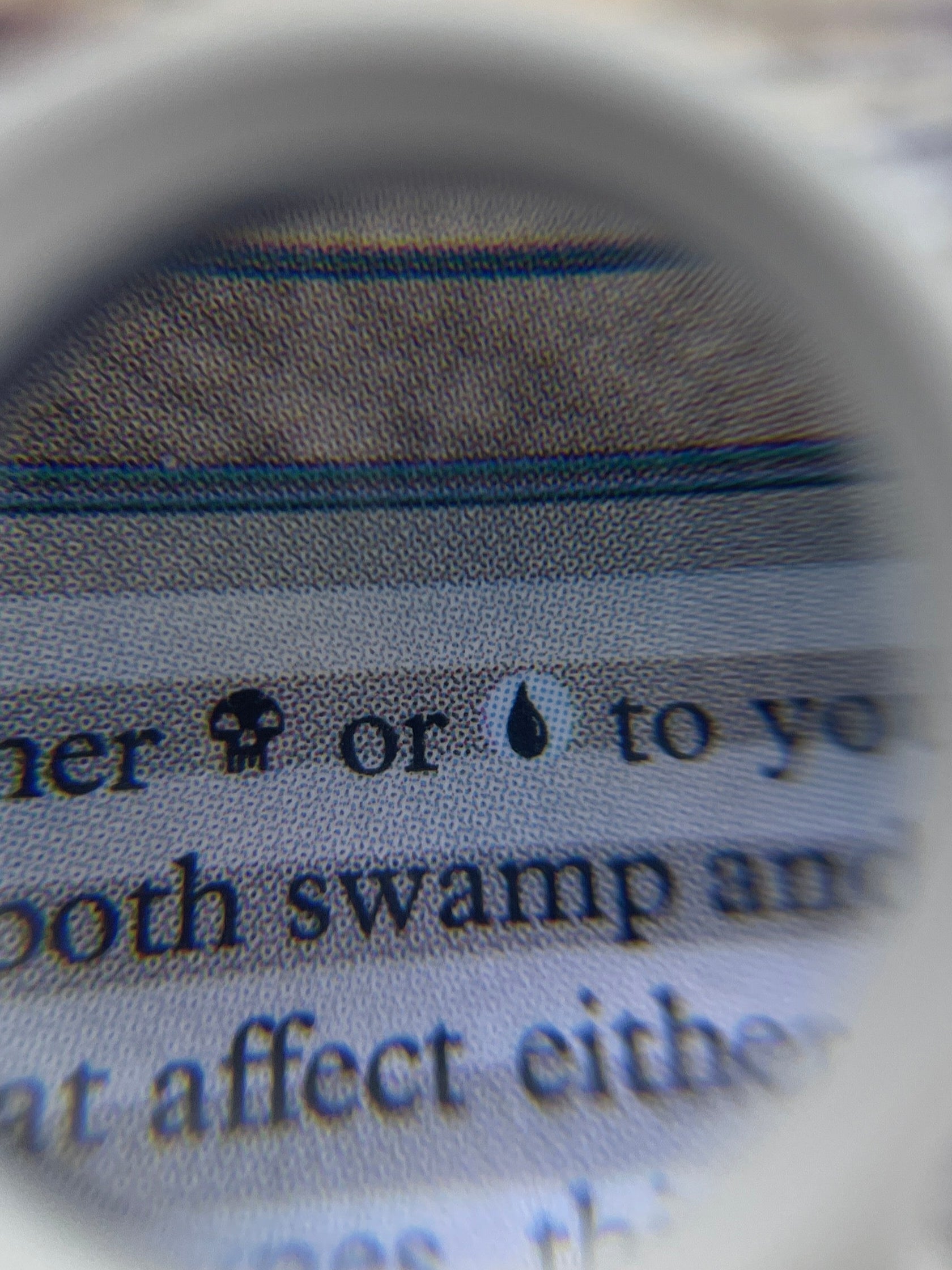 Close-up of a card with text and an image, magnified by a magnifying glass.