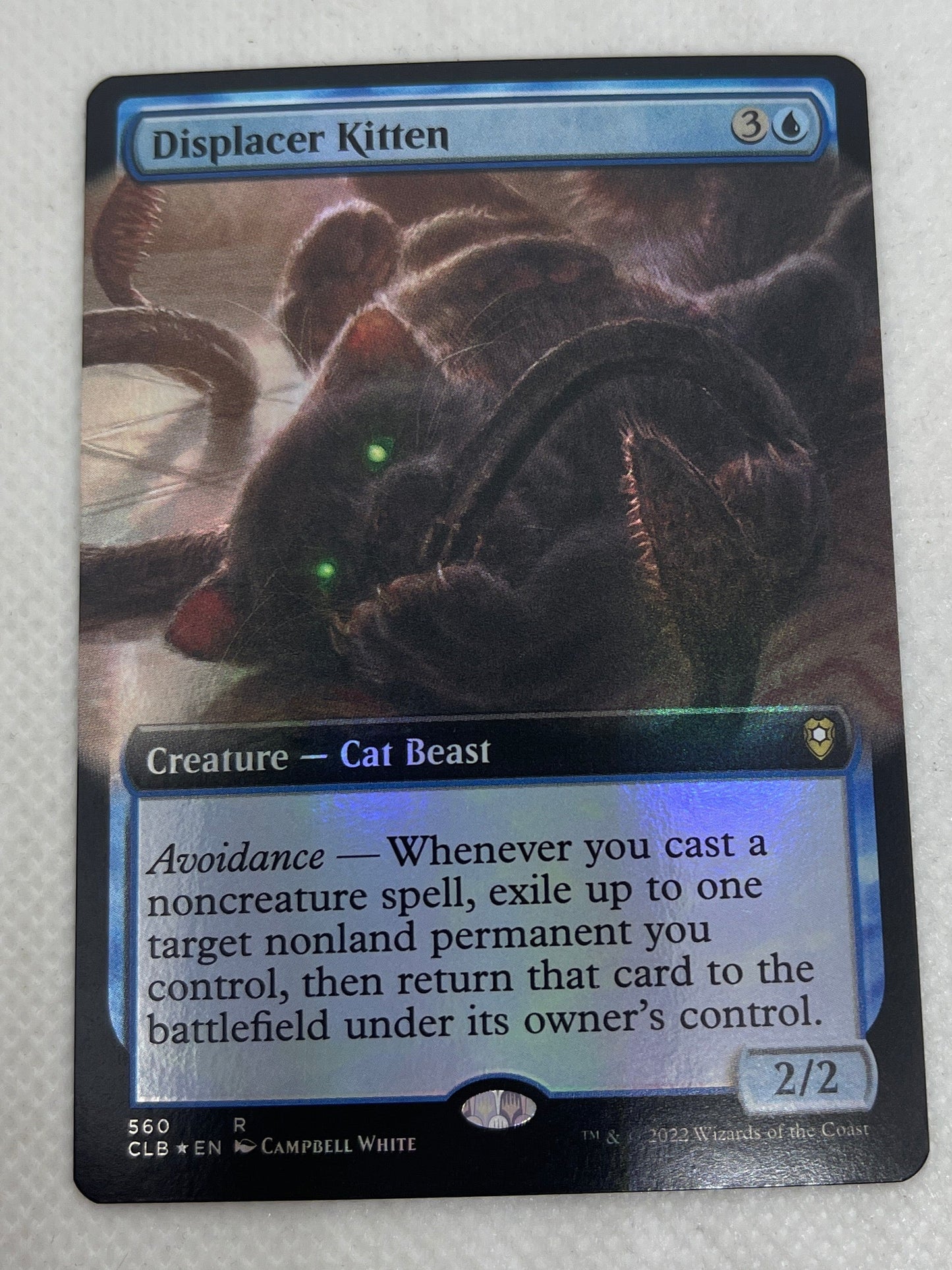 Trading card featuring a dark creature on a light gray background